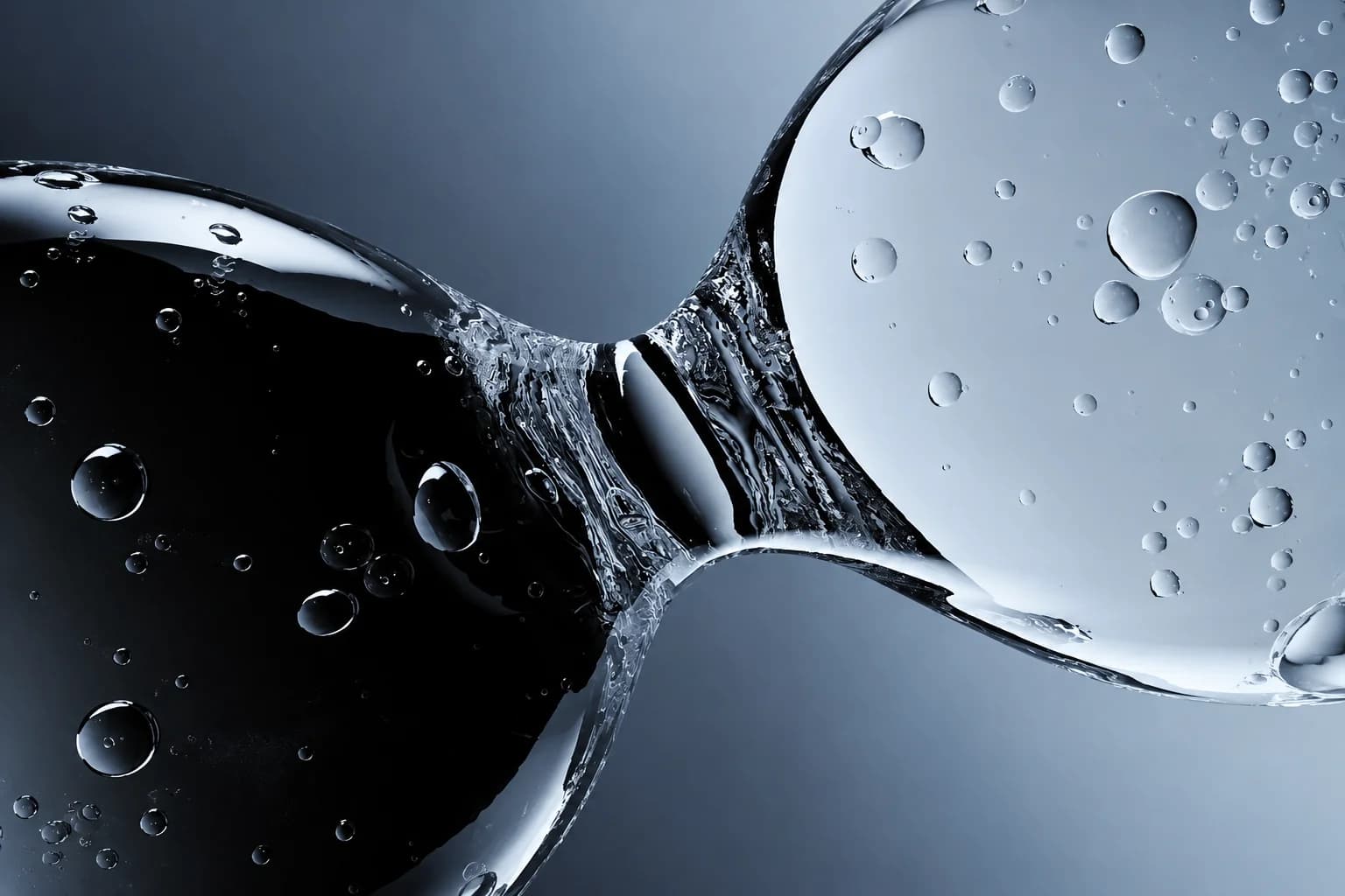 Merging liquid spheres macro photography representing pristine water precision at Oceanflo RO water bottle plant